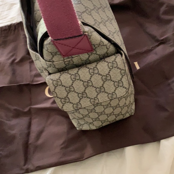 Gucci diaper bag with a pink handle changing pad